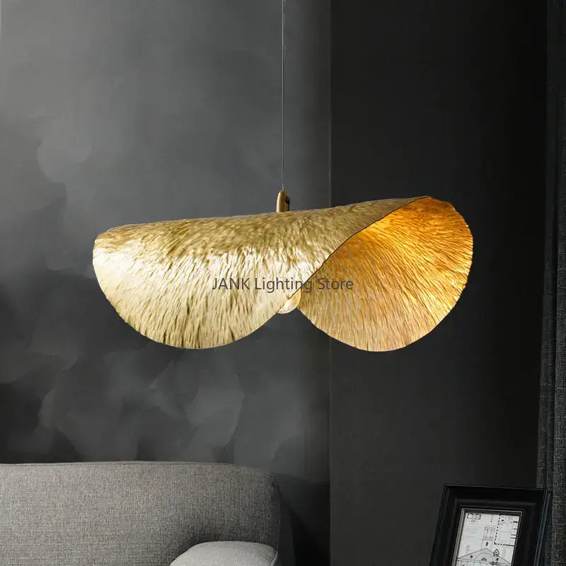 Golden decorbites lotus leaf pendant lamp with textured metallic finish hanging from slender cord for living spaces