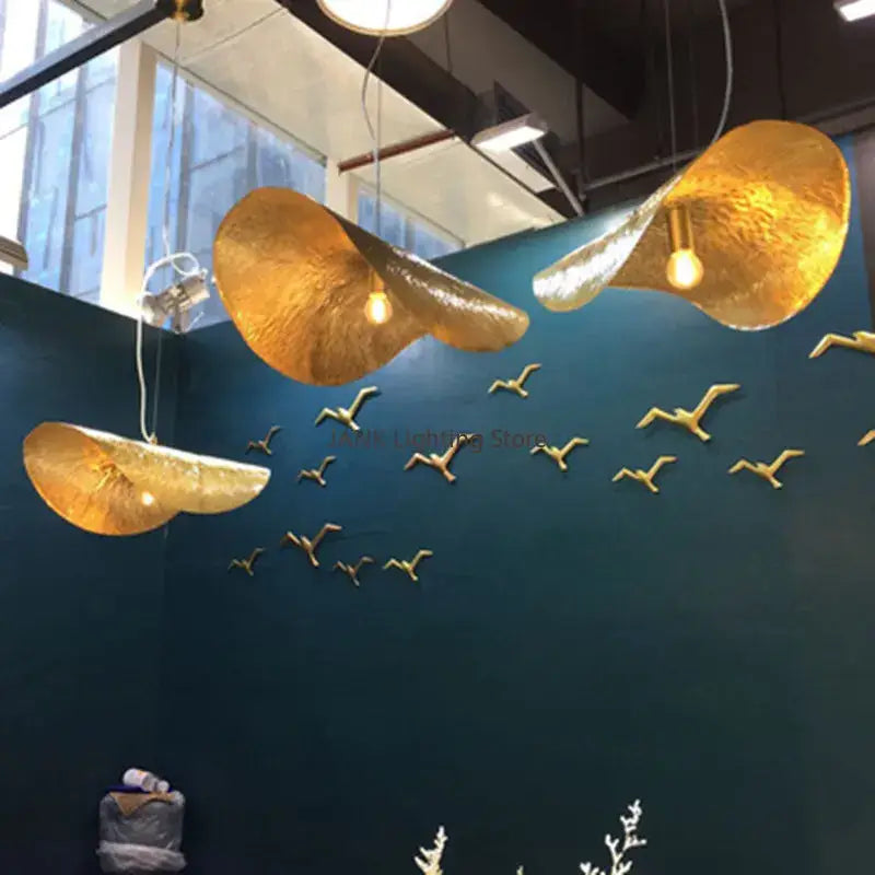 Elegant copper decorbites lotus leaf pendant lamp with golden textured lotus leaf hat design and warm glowing bulbs