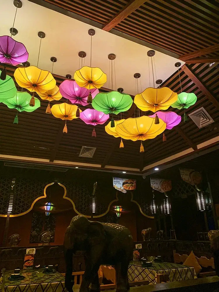 Vibrant multi-colored decorbites lotus leaf lantern pendant light made of fabric hanging in kitchen or restaurant setting