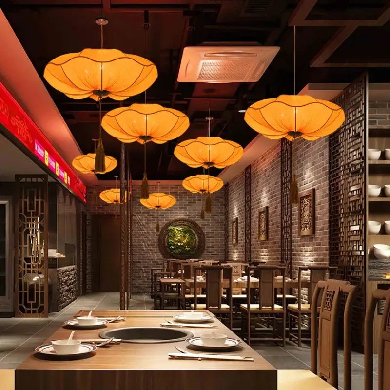 Warm orange fabric pendant light with tassels from decorbites lotus leaf lantern for kitchen and restaurant use