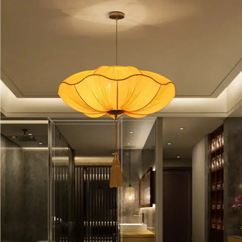 DecorBites lotus leaf pendant light with warm yellow fabric shade and wooden accents for kitchen and restaurant lighting