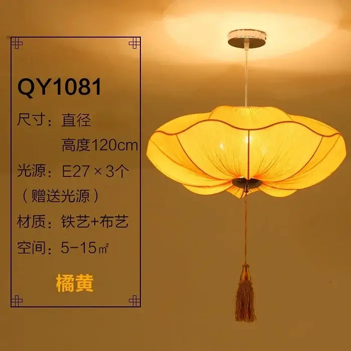 A warm orange-yellow decorbites lotus leaf lantern pendant light with fabric petals metal frame and attached tassel