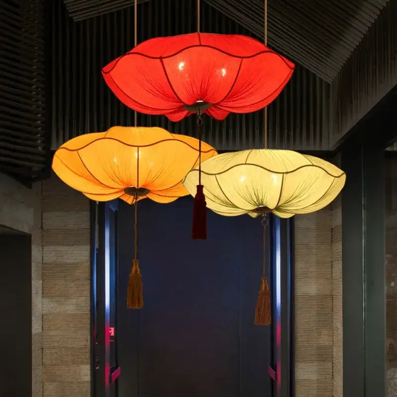 Three hanging decorbites lotus leaf pendant lights with translucent red orange and yellow fabric shades for kitchen or restaurant