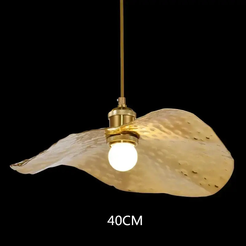 A golden hammered metal lotus leaf led pendant light with brass hardware from decorbites lotus leaf collection