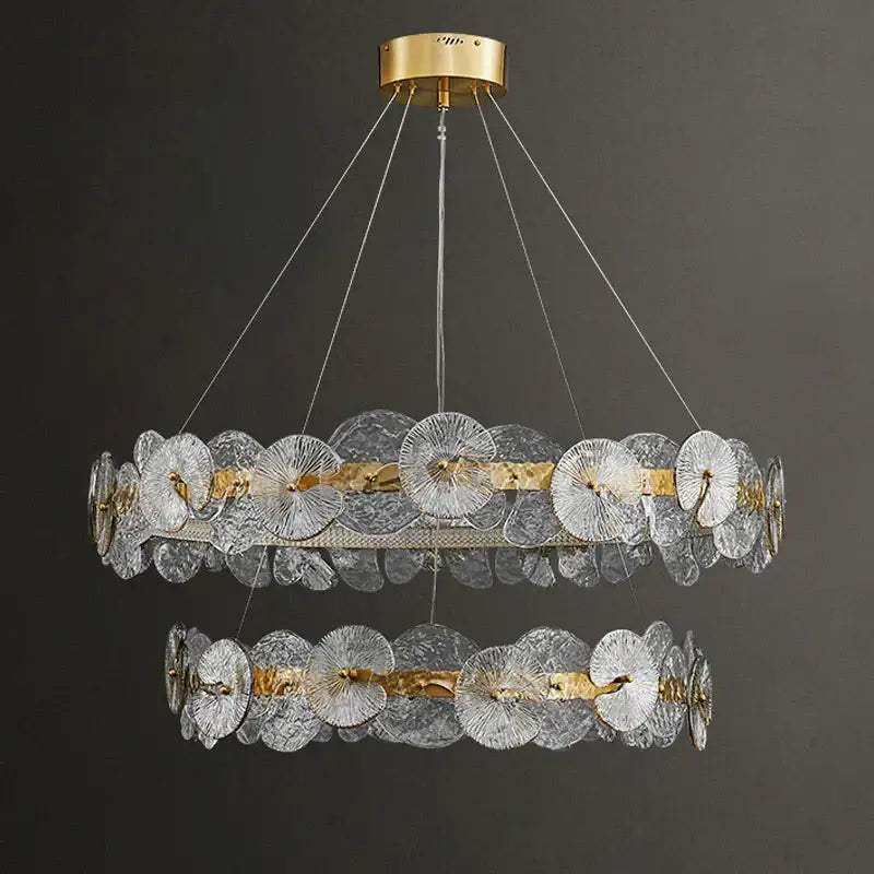 Decorbites lotus leaf led chandeliers featuring two-tiered clear textured glass discs with gold leaf led accents and brass mount