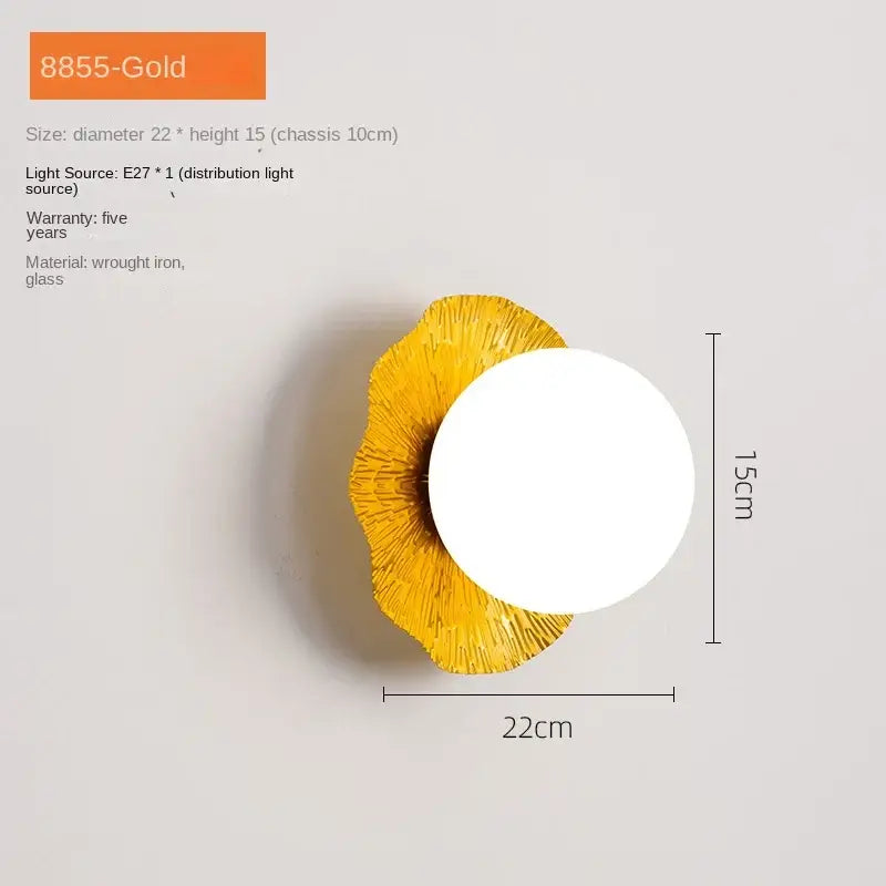 Gold-colored decorbites lotus leaf led wall lamp with textured petal base and white glass globe for modern living room