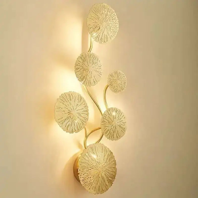 Gold-toned decorbites lotus leaf wall lights with translucent textured glass discs in vertical vine pattern for living room and bedroom