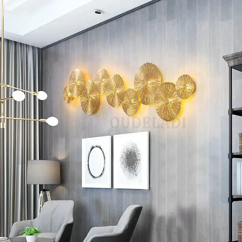 Gold-colored metallic lotus leaf led wall sconce by DecorBites with glowing backlight for industrial decor