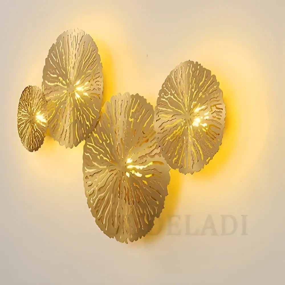 Golden lotus leaf led wall sconce by decorbites lotus leaf with intricate cut-out patterns and warm glowing lights