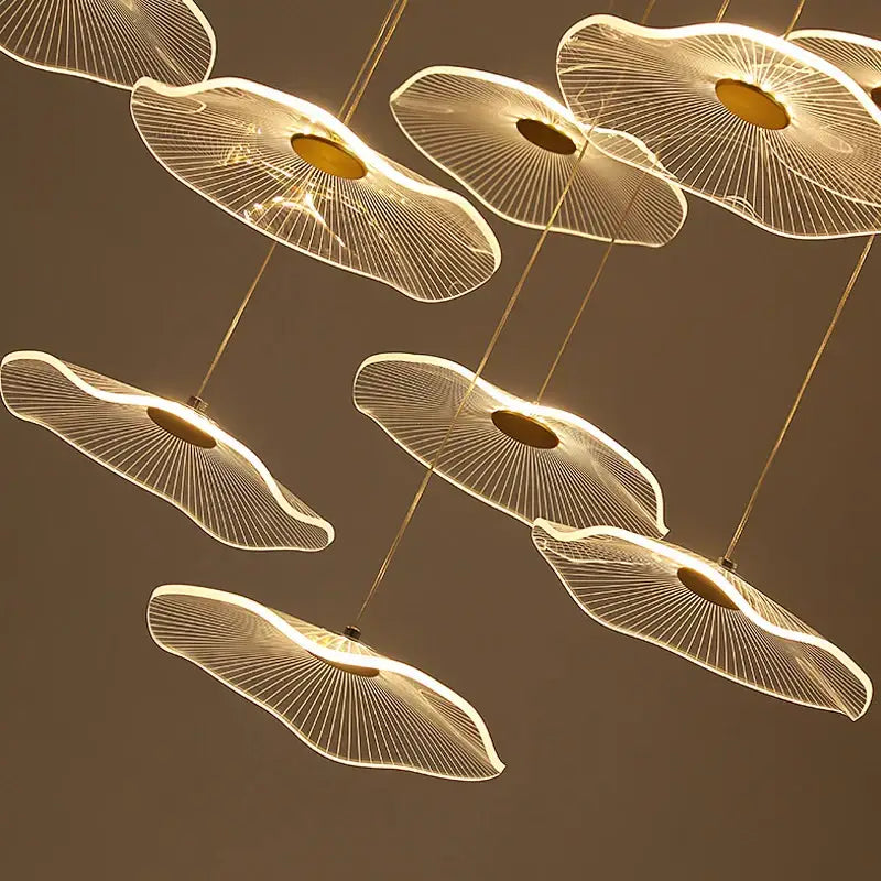 Modern gold-toned decorbites lotus leaf nordic pendant lights with intricate fan-like wireframe designs and warm glowing centers