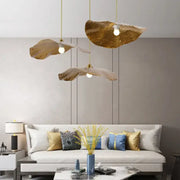 Three golden leaf-shaped decorbites lotus leaf pendant lights hang elegantly for home and cafe lighting