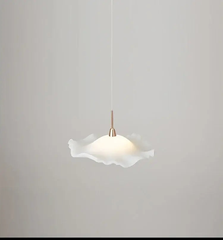 A white frosted glass decorbites lotus leaf pendant light with ruffled edges and a brass-finished stem for modern spaces