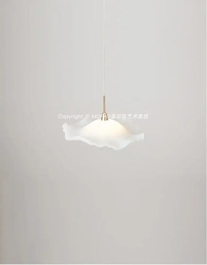 A delicate white translucent glass decorbites lotus leaf pendant light with a soft ruffled design and slender metallic stem