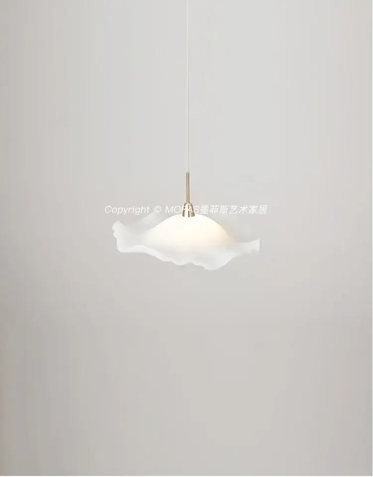 A delicate white translucent glass decorbites lotus leaf pendant light with a soft ruffled design and slender metallic stem