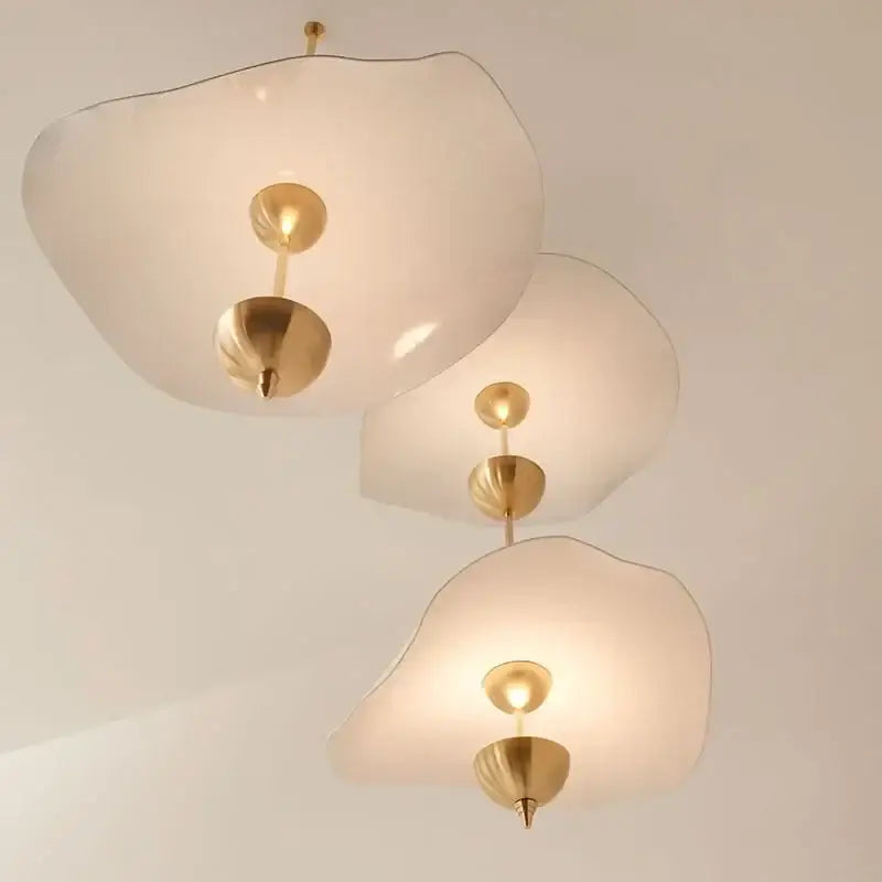 Three elegant cloud-shaped decorbites lotus leaf pendant lights with frosted glass and polished brass fixtures
