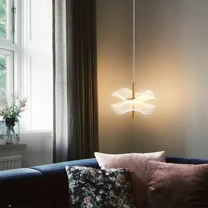 A modern decorbites lotus leaf pendant light with a translucent wave-shaped glass shade and gold-toned stem