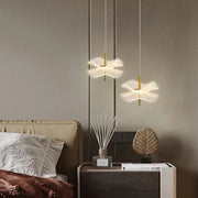 Two elegant translucent white decorbites lotus leaf pendant lights with gold-toned rods for restaurant and bedroom use