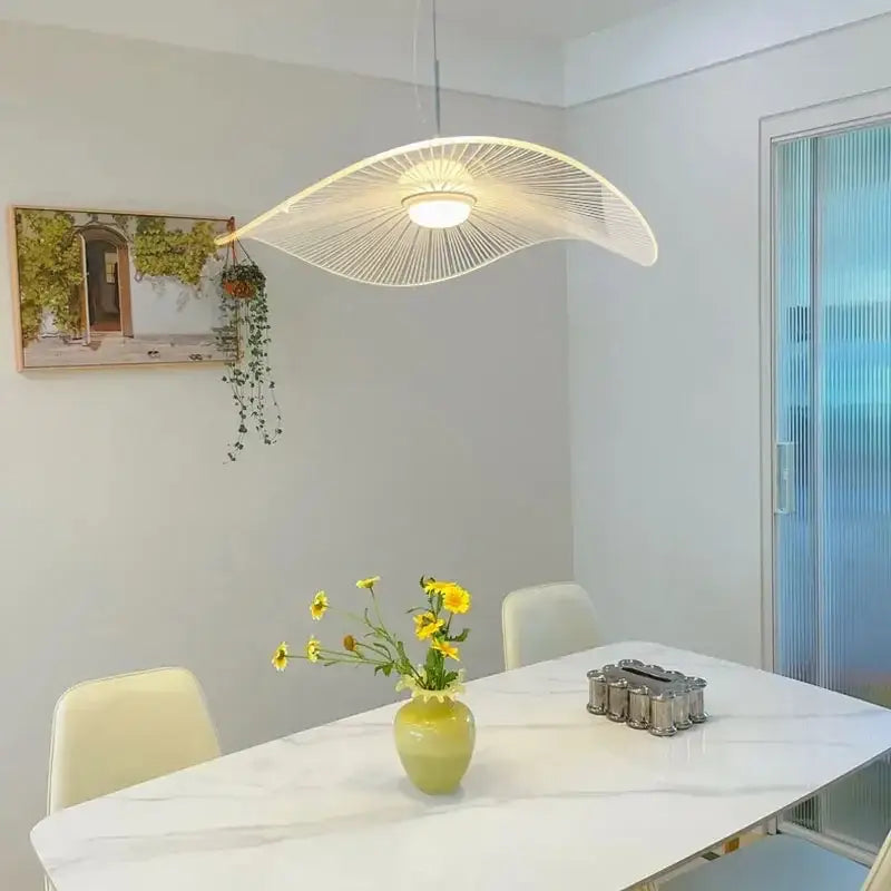 A modern white decorbites lotus leaf pendant light with sleek acrylic fan-like design and thin radial spokes
