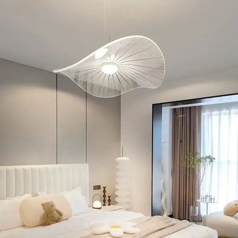A modern white pendant light with thin metal wires radiating from a circular bulb in decorbites lotus leaf pendant design