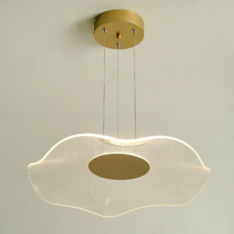 A modern gold-toned decorbites lotus leaf pendant light with a translucent wave-shaped diffuser and oval cutout