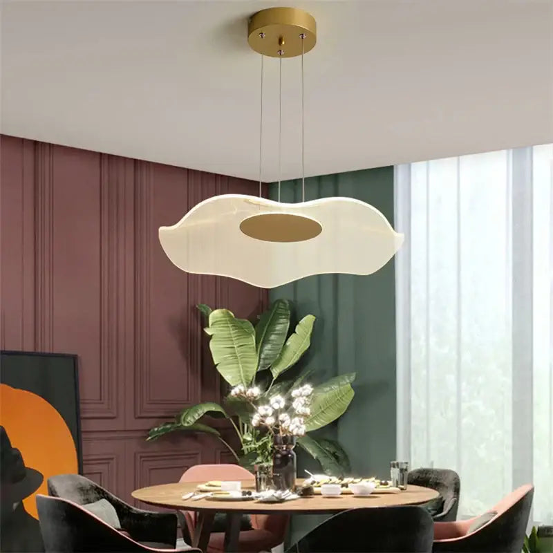 A modern decorbites lotus leaf pendant light with frosted white diffuser and gold-toned center for living room and bedroom
