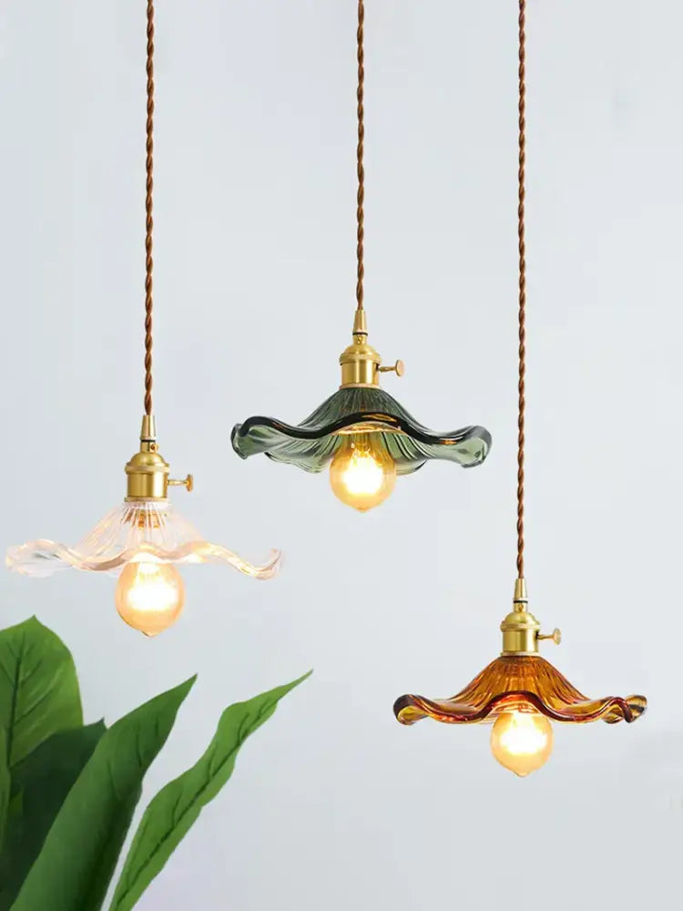 Three elegant decorbites lotus leaf pendant lights with glass flower shades in clear green and amber brass fixtures