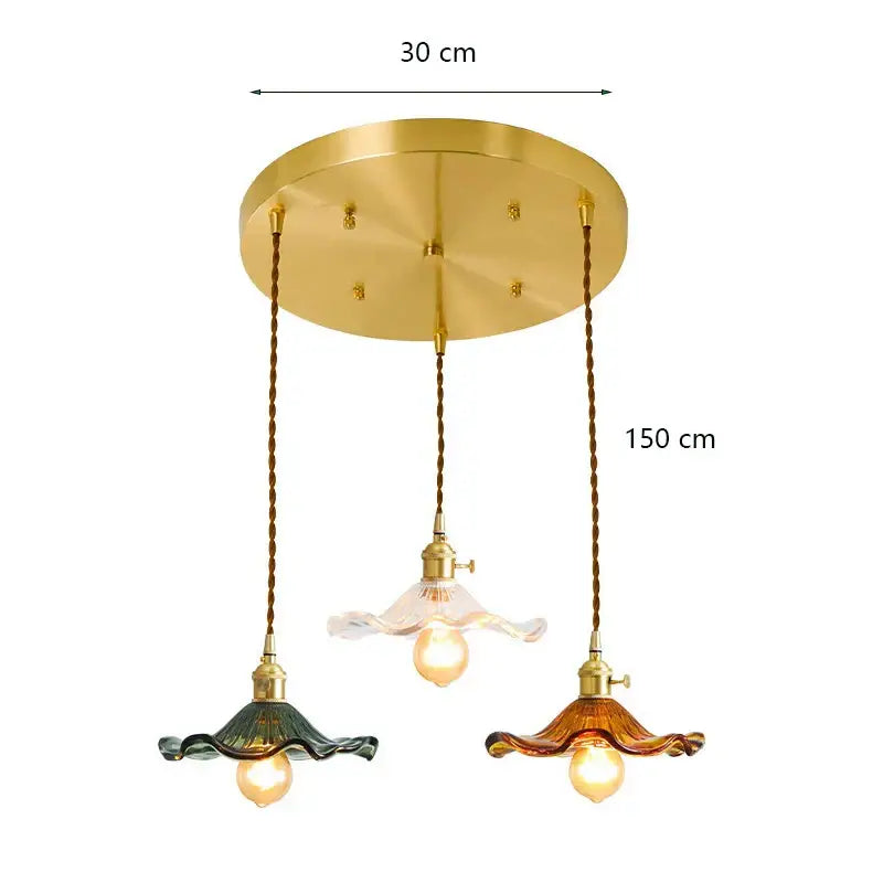 Gold-toned decorbites lotus leaf pendant lights with three green and amber glass shades suspended by twisted bronze cords