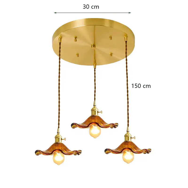 Gold-toned decorbites lotus leaf pendant lights with three amber glass shades and twisted brown cords for modern interiors