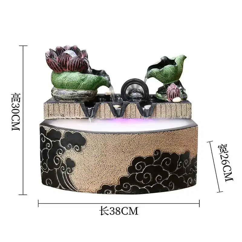 Decorbites lotus leaf water feature with textured beige base black cloud motifs and green lotus bird figures with purple light