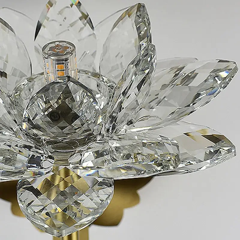 DecorBites lotus LED wall lamp with a gold-toned base and faceted crystal lotus-shaped glass petals for elegant decor