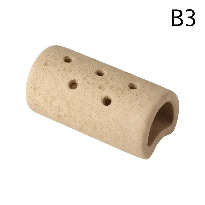 Beige ceramic reptile hide tube with ventilation holes from decorbites lotus seedpod ceramic vase set in stone sand finish