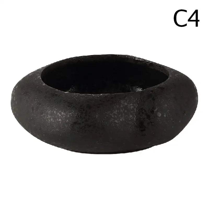Black textured ceramic vase from decorbites lotus seedpod set with stone sand finish and smooth rounded shape