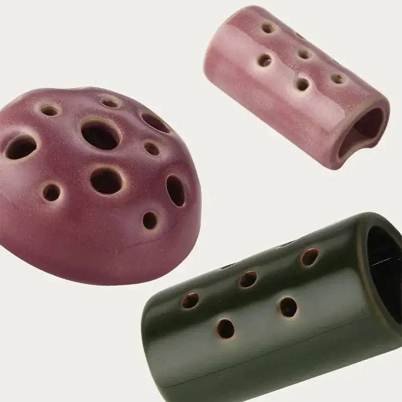 Purple and green ceramic lotus seedpod vases with multiple finger holes made of stone sand material