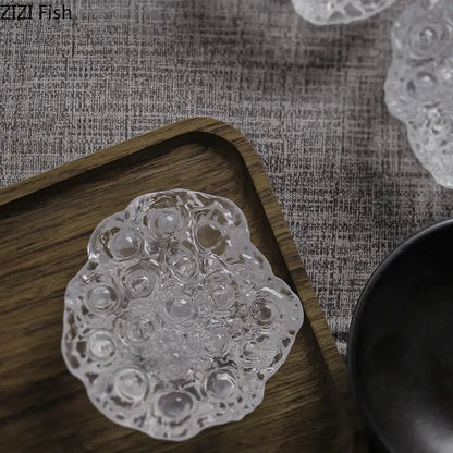 Clear intricately textured glass dish with scalloped edge and bubble patterns in decorbites lotus seedpod resin sculpture