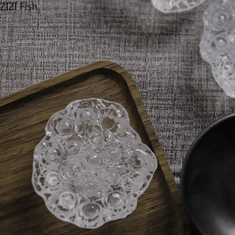 Clear intricately textured glass dish with scalloped edge and bubble patterns in decorbites lotus seedpod resin sculpture