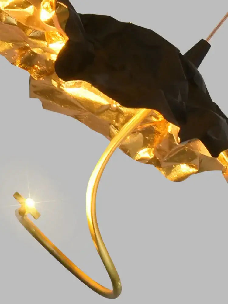 A sculptural black and gold decorbites lotus staircase pendant light with crumpled metallic finish for elegant lighting