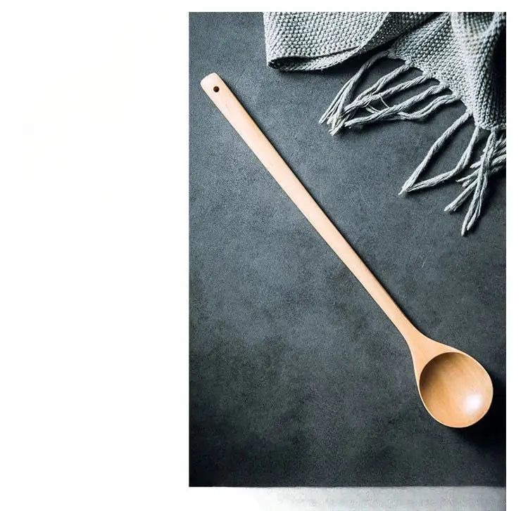 A smooth light-colored wooden lotus wooden spoon with a long handle by decorbites lotus for eco-friendly cooking