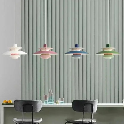 Four pastel-colored layered loui led pendant lights with modern design hang above dining table in kitchen or living room