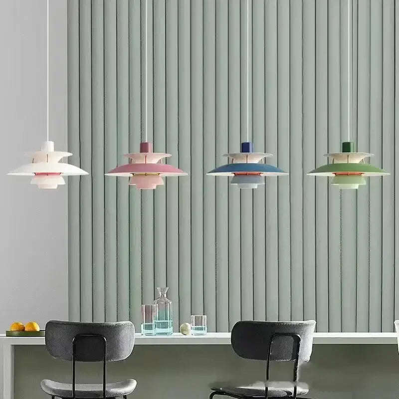 Four pastel-colored layered loui led pendant lights with modern design hang above dining table in kitchen or living room