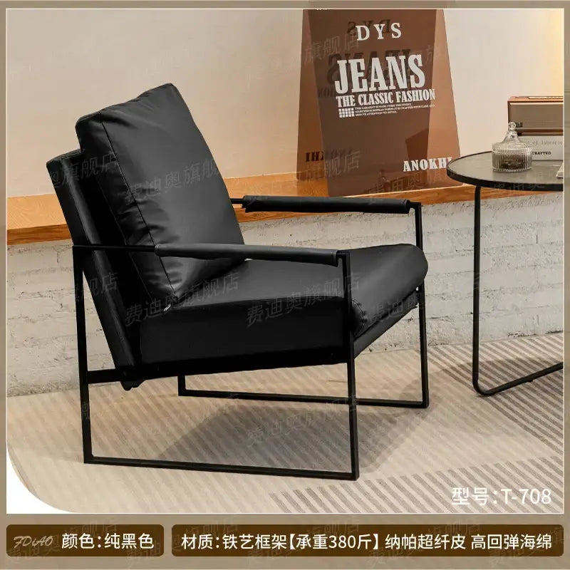 Black leather DecorBites™ single sofa chair with sleek metal frame for coffee shop and hotel balcony seating