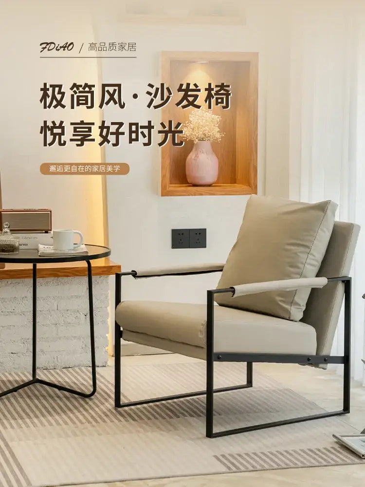 Beige upholstered single sofa chair with sleek black metal frame for coffee shop and hotel balcony use