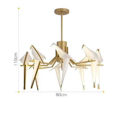 Gold-toned decorbites love bird chandelier featuring white paper birds and illuminated glass panels for dining room lighting