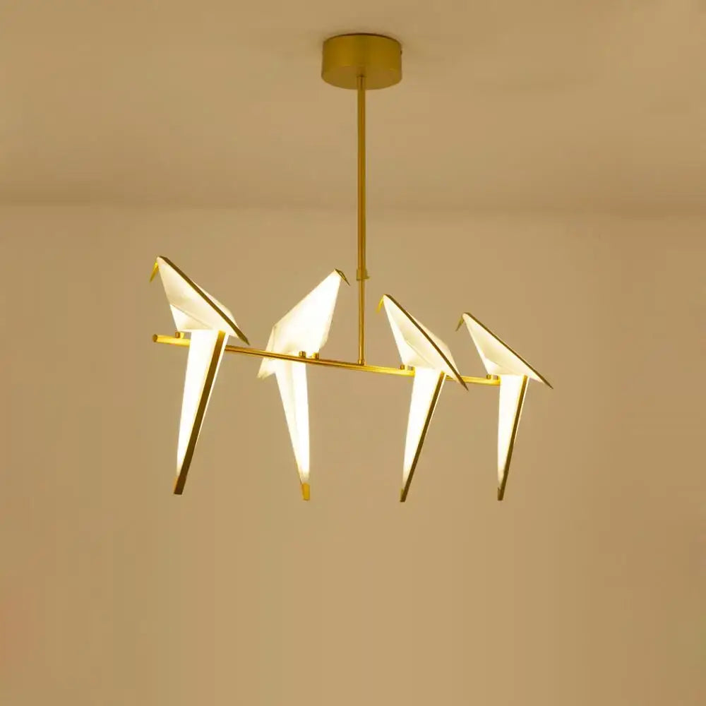 Gold-toned decorbites love bird chandelier lighting with four illuminated origami-style birds on a horizontal bar