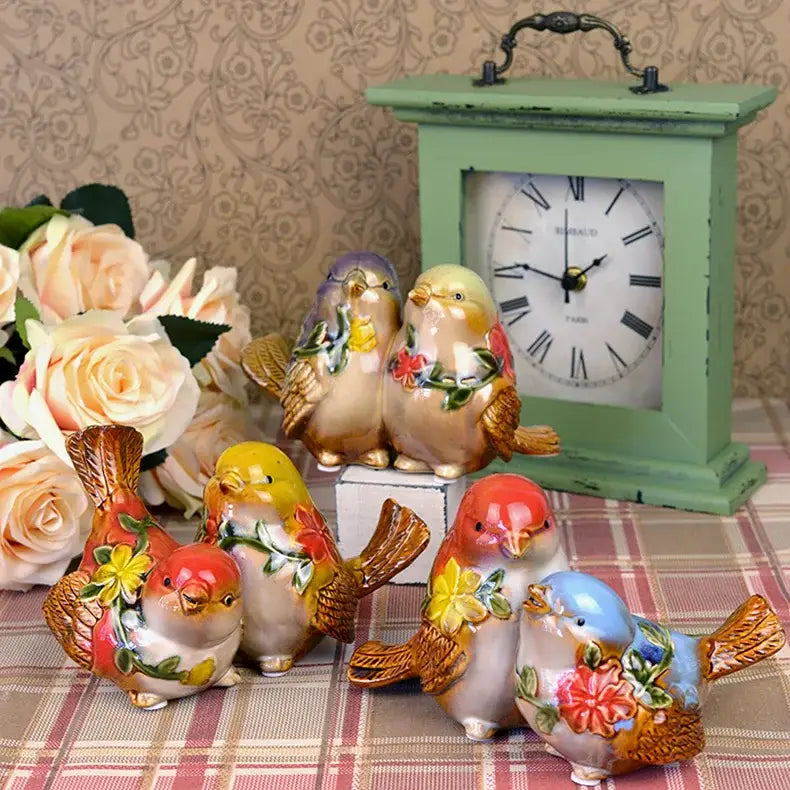 A collection of colorful decorbites love birds porcelain couple ornaments with painted floral patterns and glossy finish