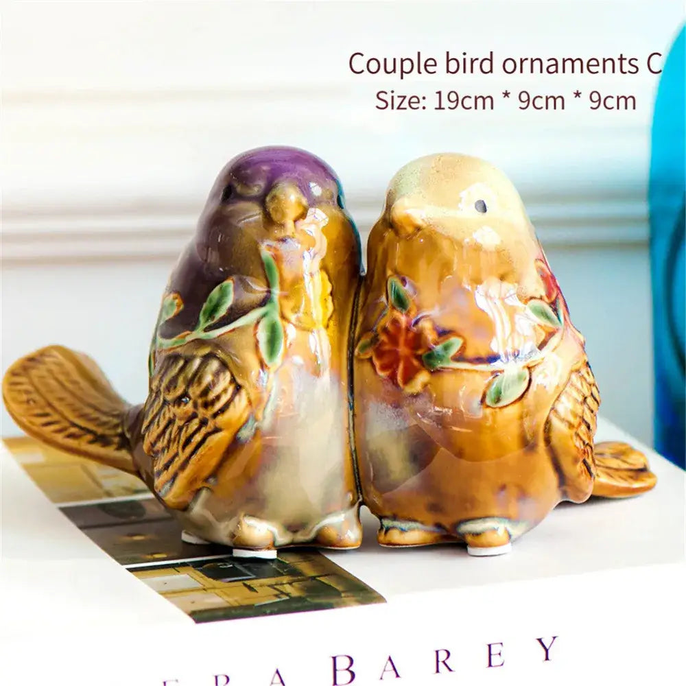 Ceramic couple bird ornaments in warm brown and purple with hand-painted floral details from decorbites love birds porcelain collection