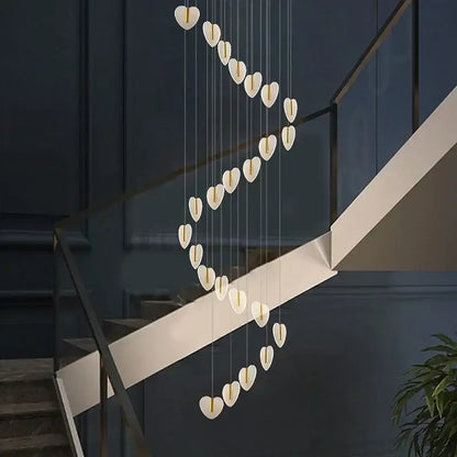 A modern decorbites love chandelier with white heart-shaped crystal lights in a cascading gold design for living room