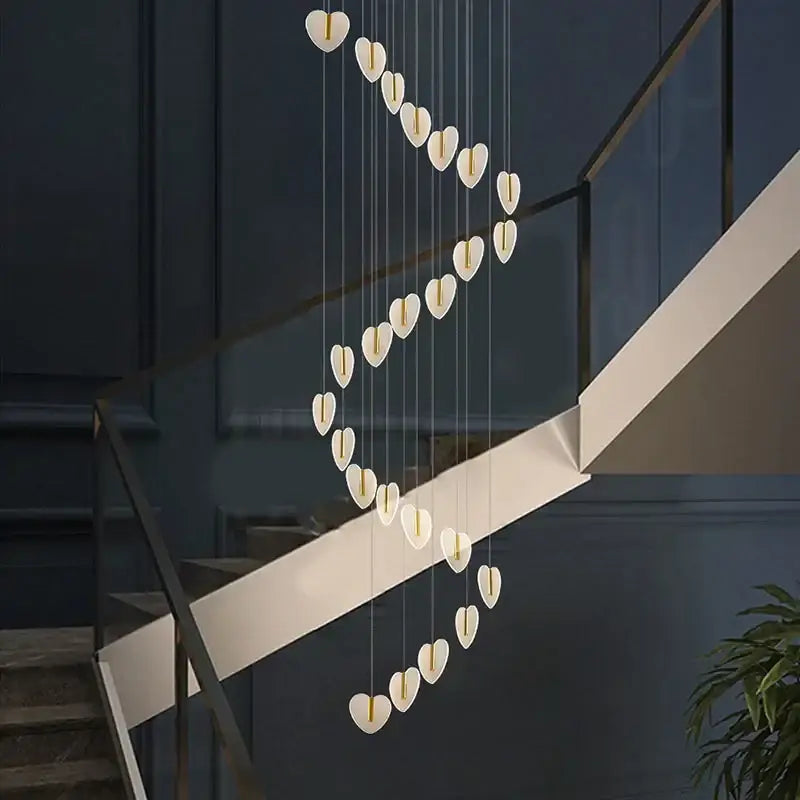 A modern decorbites love chandelier with white heart-shaped crystal lights in a cascading gold design for living room