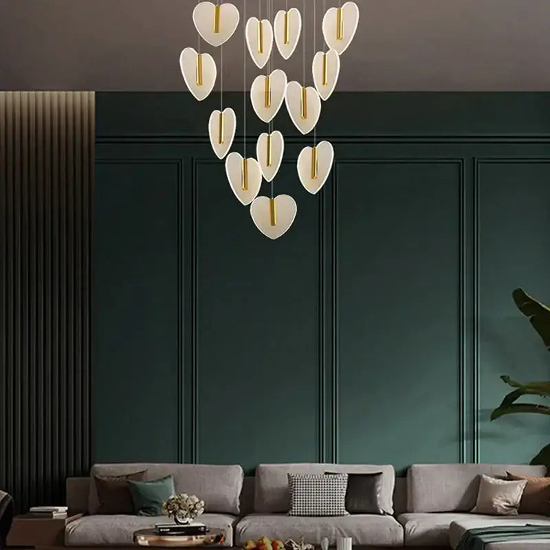 A modern decorbites love chandelier with white heart-shaped lights and gold crystal accents for staircase and living room