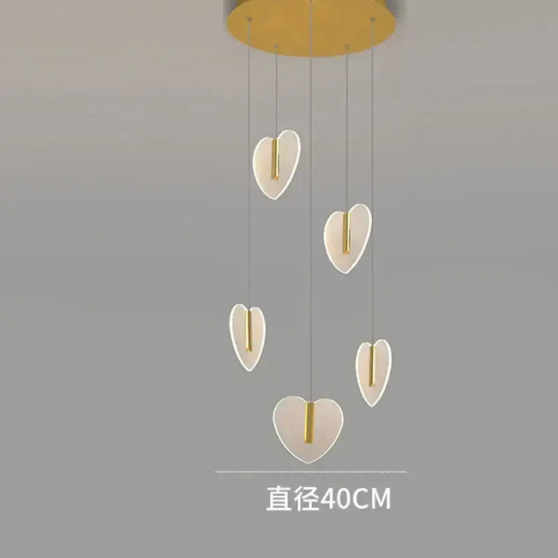 Modern pendant light fixture with five heart-shaped lamps in gold and brass by decorbites love chandelier for living room