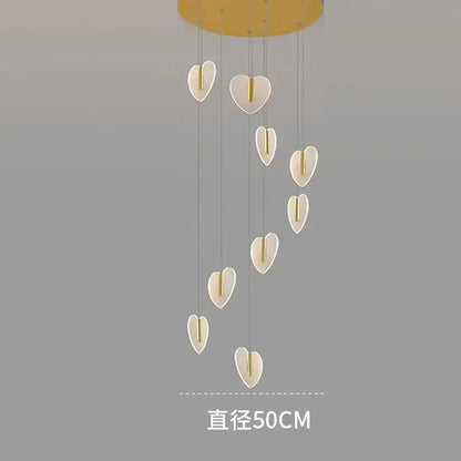 A modern decorbites love chandelier with white heart-shaped lights and gold crystal mount for staircase and living room